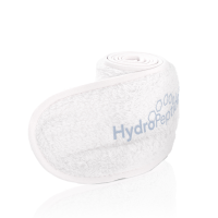 A white facial headband rolled in a coil with a embroidered light blue Hydropeptide logo in front of a white background